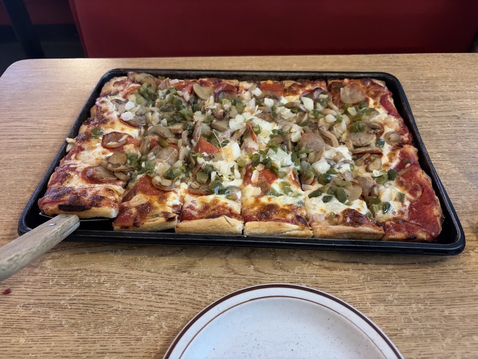 Pizza restaurant interior with warm lighting.